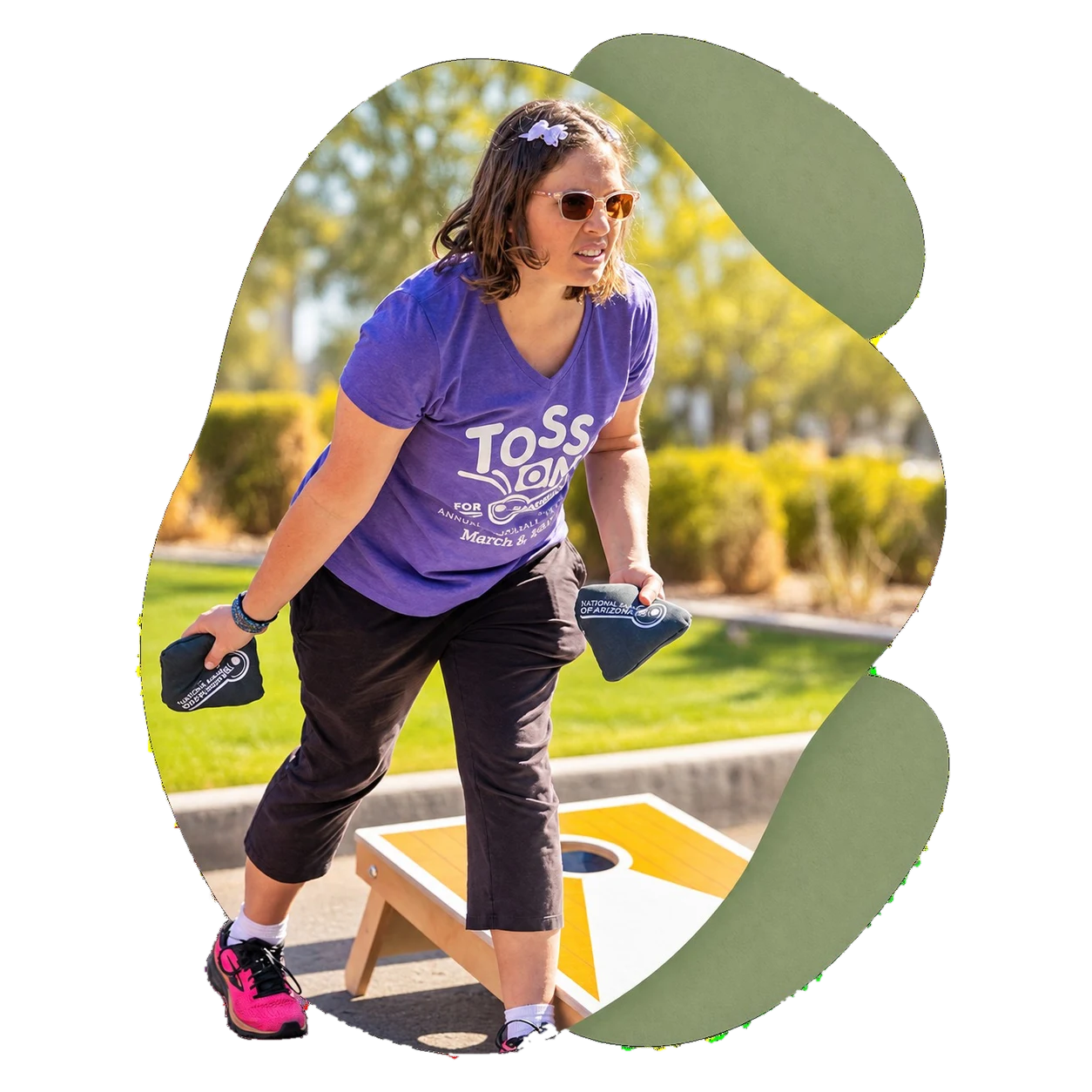 A Treasure House resident lining up a throw at Cornhole for a Cause