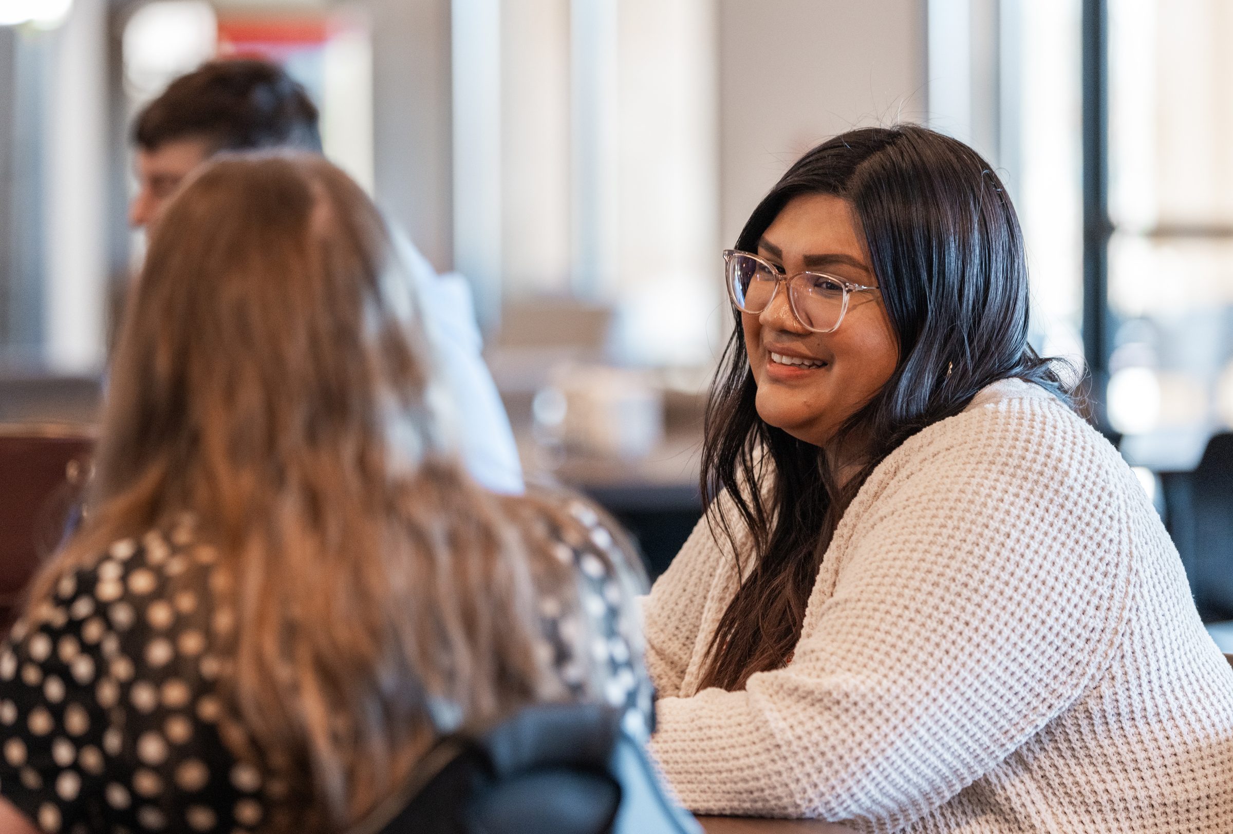 A life coach and a resident talking across a table