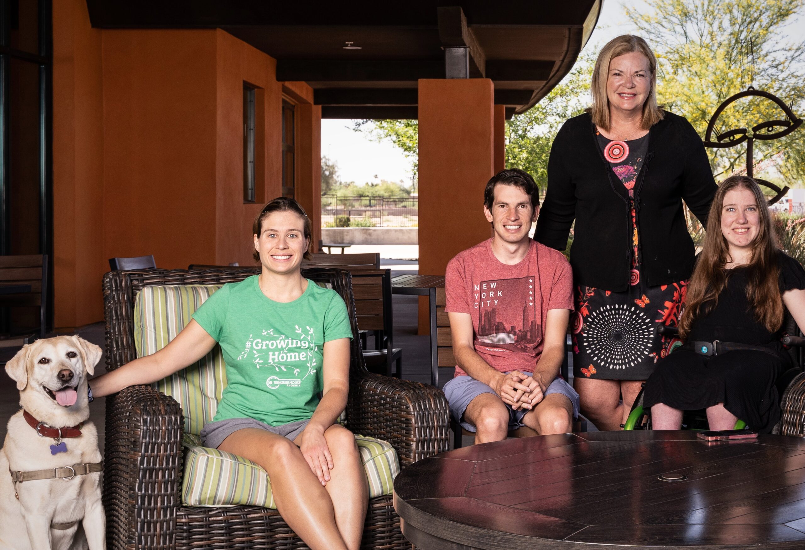 Residents and staff relaxing together on the Treasure House patio