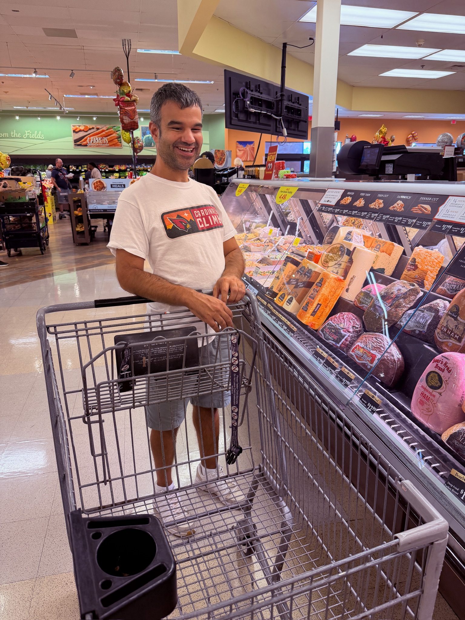 A resident pushing a cart through the grocery store