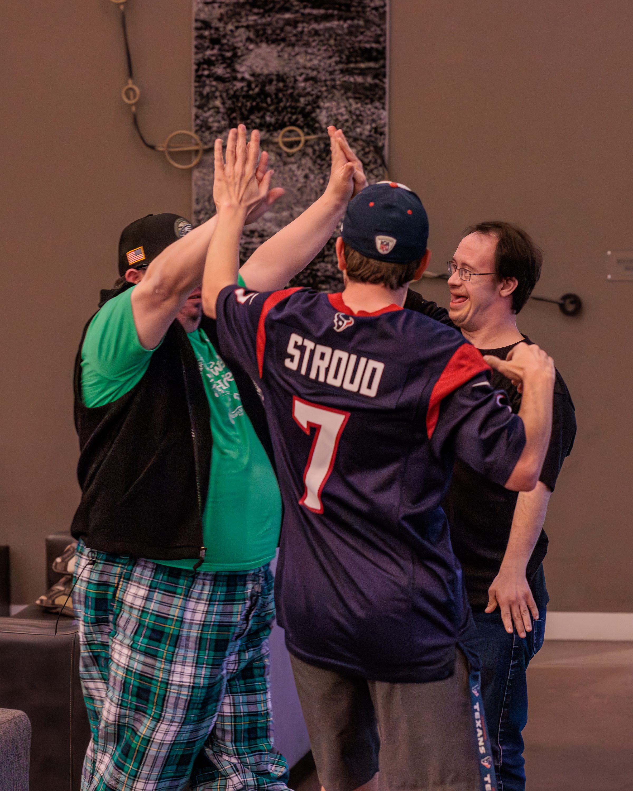 Two Treasure House residents sharing a high five