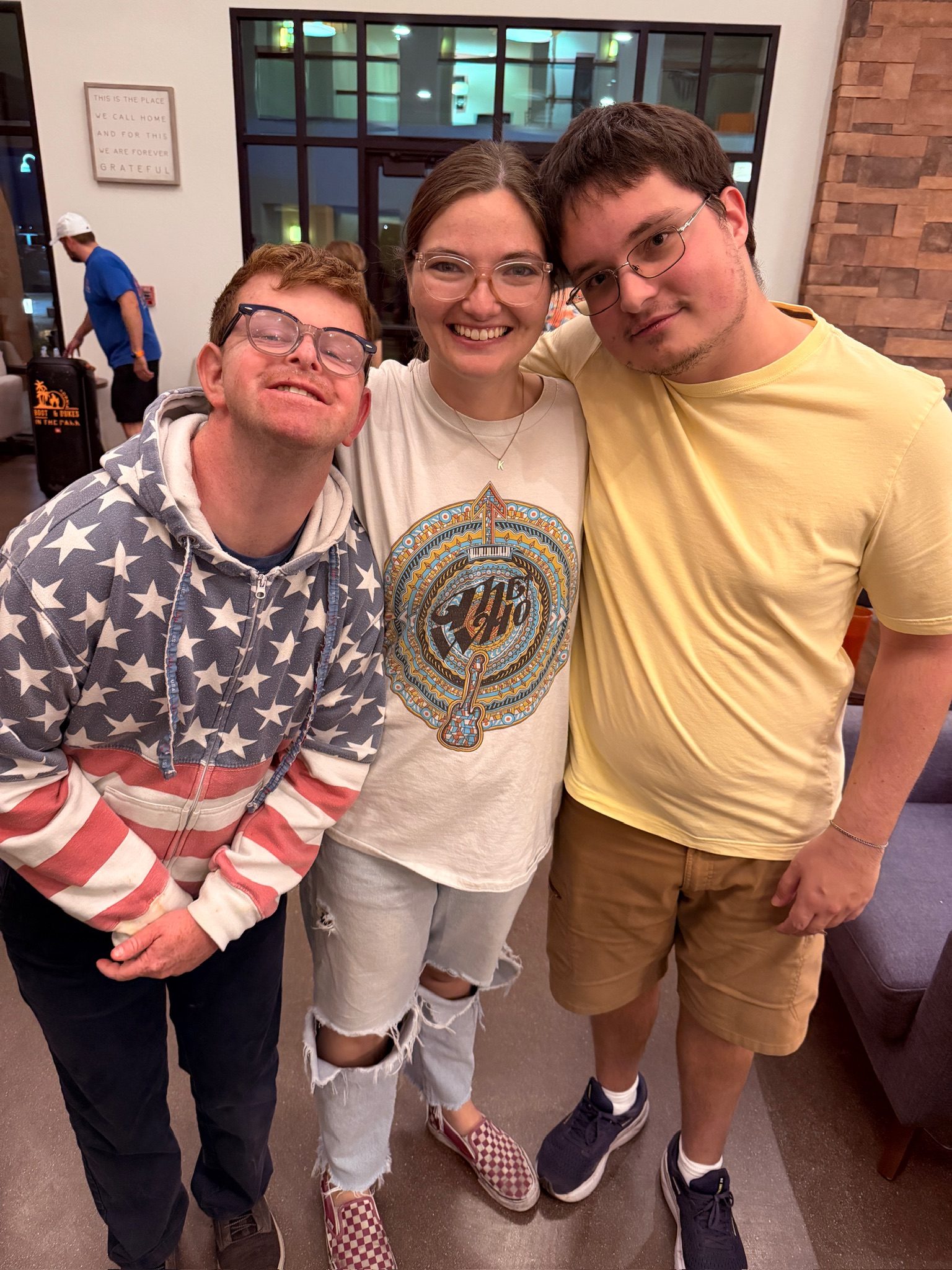 Three Treasure House residents with their arms around each other