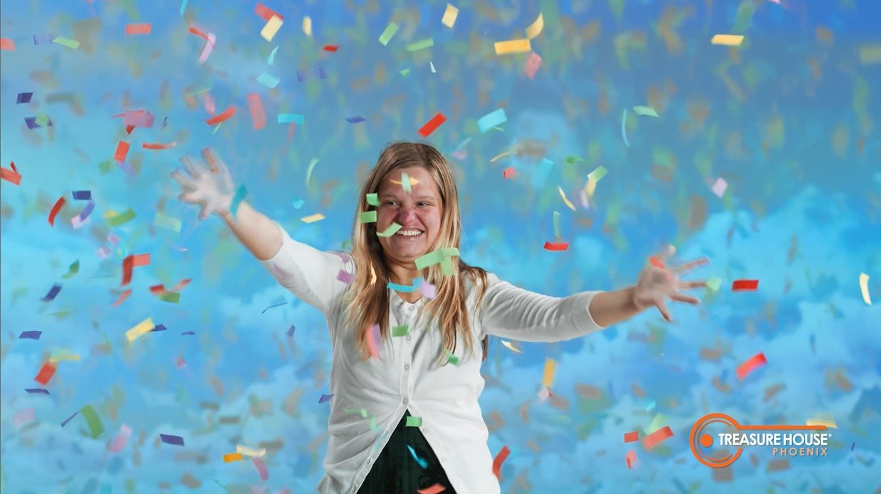 Katie celebrating in a shower of confetti